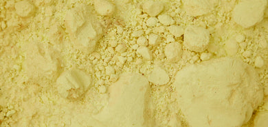 Close-up of light yellow powder with a textured surface